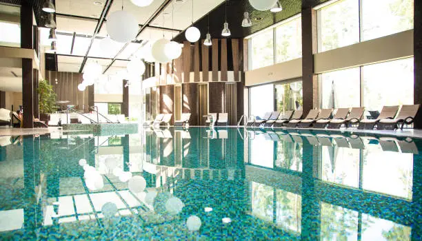 Photo of Luxury indoor swimming pool in a modern hotel. Spa and treatment