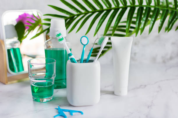 set of dental hygiene products on white marble table. - dental floss brushing teeth dental hygiene dental equipment imagens e fotografias de stock