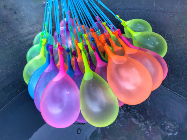 Colorful water balloons Colorful water balloons with water drops on black background. water balloon stock pictures, royalty-free photos & images