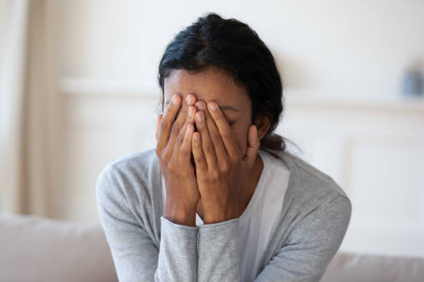 istock Sad and crying black woman cover face with hands 1257791096