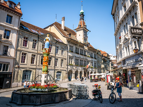 Lausanne Switzerland , 25 June 2020 : Place de la Palud or Palud square with the iconic Justice fountain and the Lausanne city hall in Lausanne Switzerland
