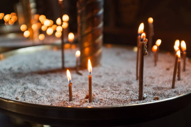 istock Candles in the Church, yellow lights and prayers. 1257795507