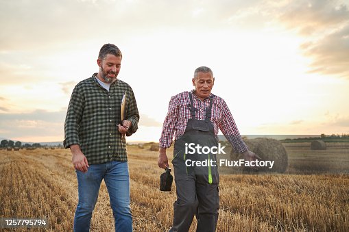 istock After they checked a quality of hay contented father and son going home 1257795794