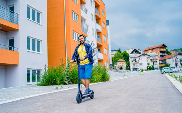 istock Man riding electric kick scooter 1257797683