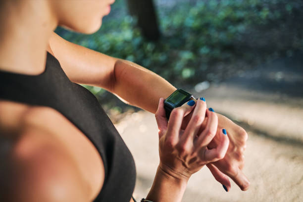 istock Female runner checking her pulse trace on a smart watch and adjusting another route of run 1257797777