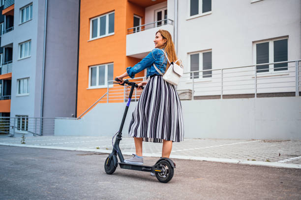 istock Female commuter with electric push scooter 1257798176