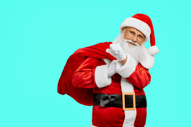 istock Smiling Santa Claus holding bag with presents. 1257799789