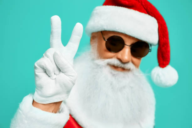 istock Santa Claus in sunglasses showing peace. 1257800005