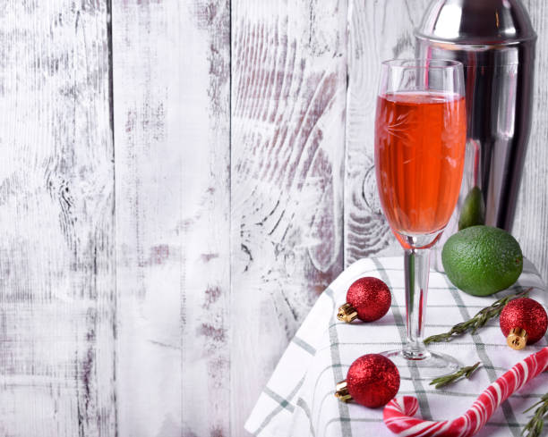 istock Red alcoholic drink in a tall glass surrounded by Christmas attributes 1257801403