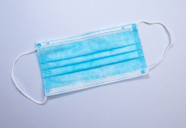 istock Three-layer surgical mask for covering mouth and nose from bacteria. Protection concept. 1257801501
