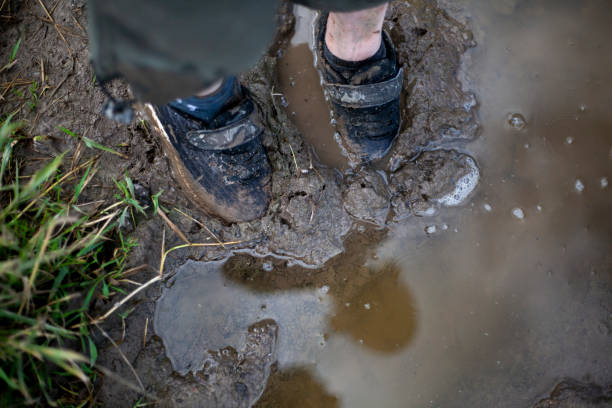 istock The child's feet are covered in mud. 1257802397