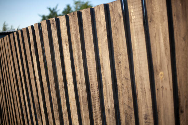istock Old wooden fence on the street. 1257802475