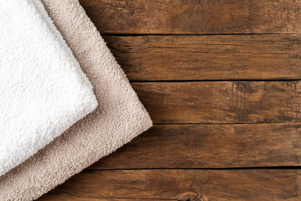 istock Overhead shot of clean folded towels on rustic wooden table with copyspace 1257805396