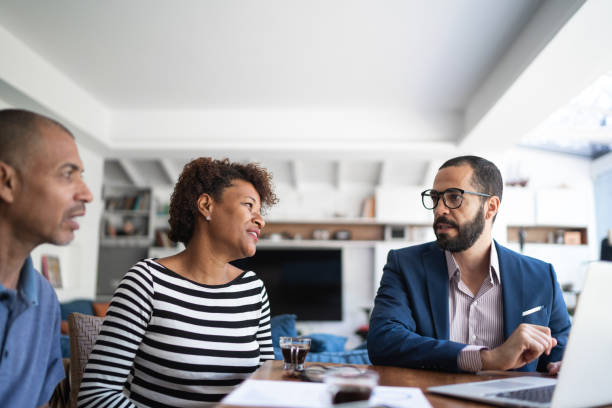 istock Couple talking to financial advisor at home 1257805714