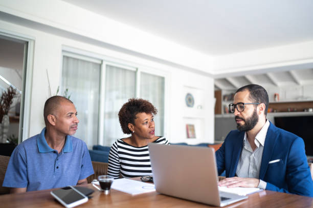 istock Couple talking to financial advisor at home 1257805717