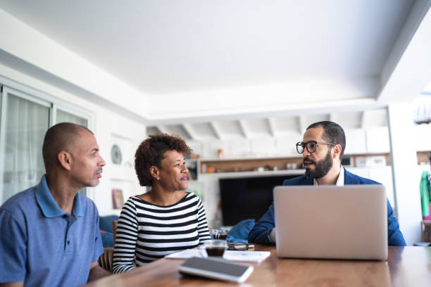 istock Couple talking to financial advisor at home 1257805721