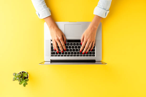 istock Elegant office desktop with female hands working on laptop. Business workspace 1257806455