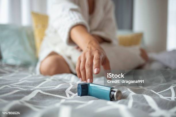 Asmathic Girl Catching Inhaler Having An Asthma Attack Stock Photo - Download Image Now