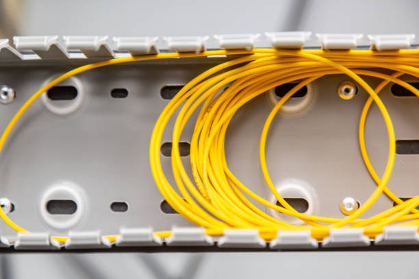 istock Yellow fiber optic cables coiled into a spool in an organizer. Horizontal orientation 1257808720