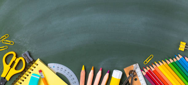 istock School supplies on blackboard. Back to school concept. 1257808769