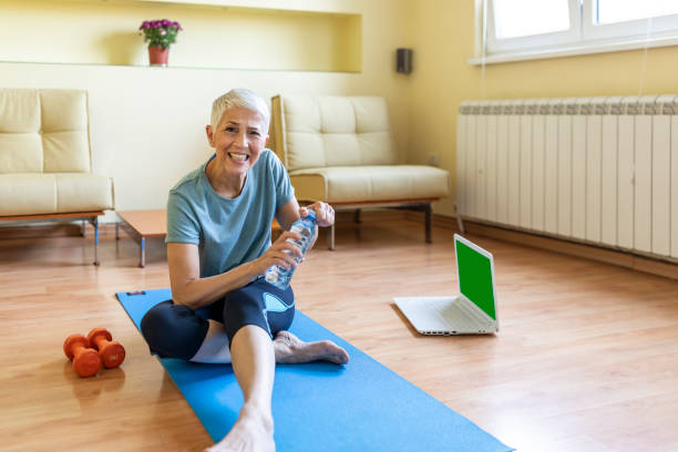 istock Older woman doing yoga indoors 1257809856