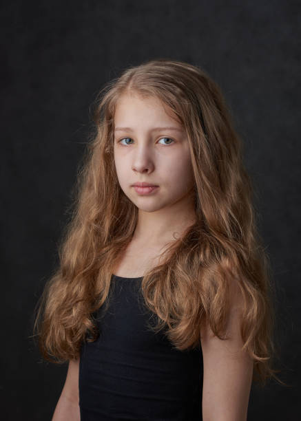 istock Young girl in black top 1257810674