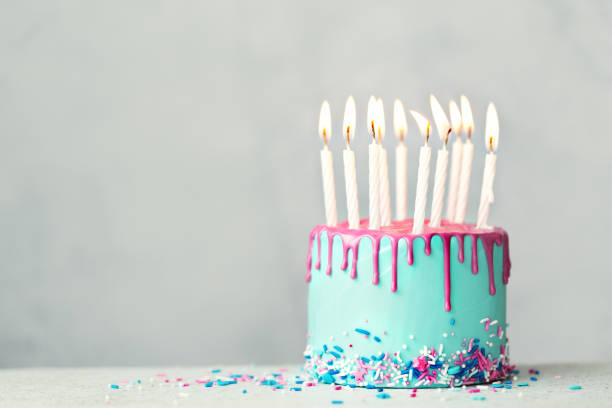 istock Birthday cake with pink drip icing and ten candles 1257810760
