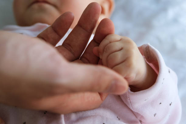 istock Father's male hand holding a child's small hand 1257810970