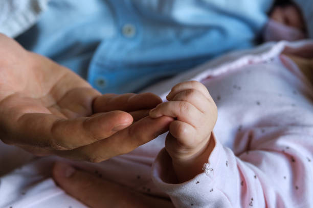 istock Father's male hand holding a child's small hand 1257812411
