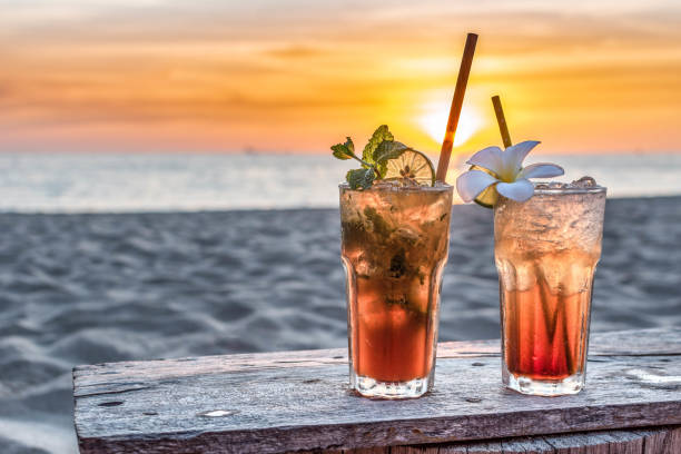 drinks with blur beach and sunset in background drinks with blur beach and sunset in background beach goa party stock pictures, royalty-free photos & images