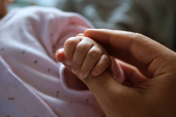 istock Father's male hand holding a child's small hand 1257813387