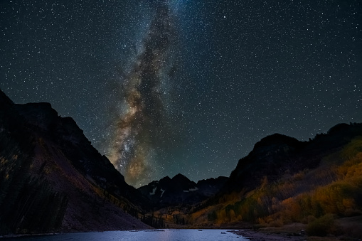 Maroon Bells lake wide angle view of dark night milky way sky in Aspen, Colorado with rocky mountain peak in October 2019 autumn