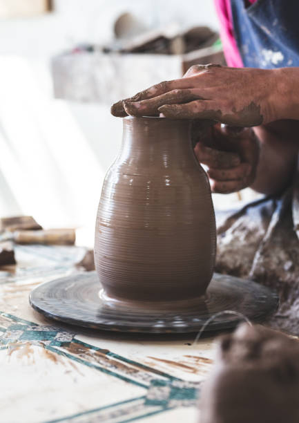 istock Potter hands making in clay on pottery wheel. Potter makes on the pottery wheel 1257815002