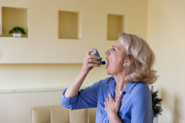 istock Senior Woman with Asthma is Using an Inhaler. 1257815079