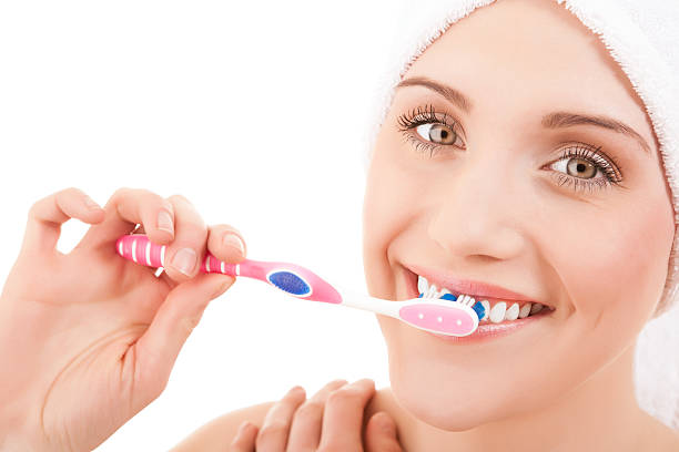 istock Woman wearing a towel brushing her teeth 125781644