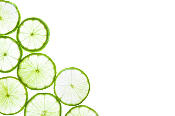 istock Green lime slices isolated on white background. 1257816851