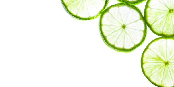 istock Green lime slices isolated on white background. 1257816852
