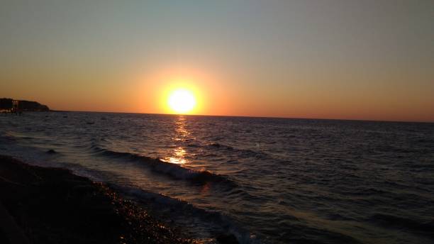 istock evening sun sets over the sea 1257818684