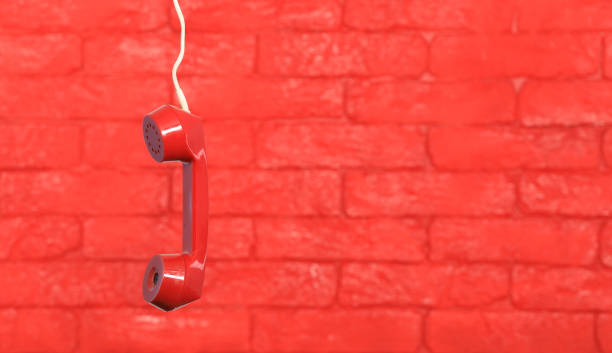 istock red telephone receiver on red brick wall 1257818763