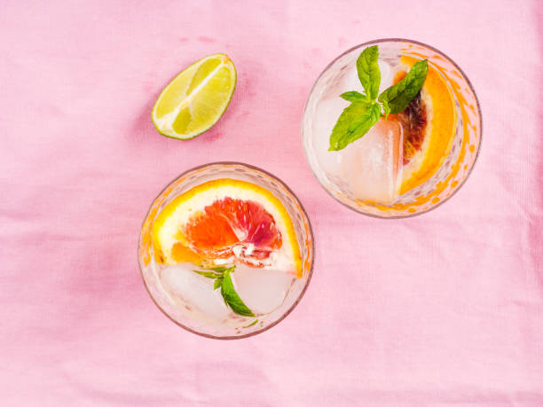 istock Summer iced citrus drink with mint on pink napkin 1257820137