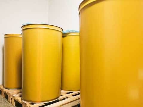 yellow metal barrels for 200 liters of steel.transportation and storage of substances.industry.chemical production.liquid food storage.container use of barrels in a summer cottage.for rain water