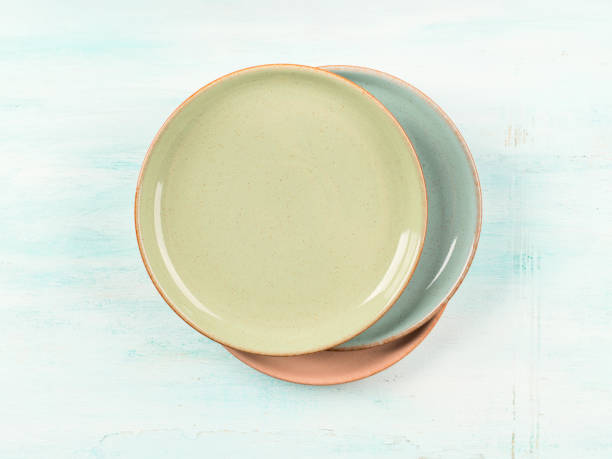 istock Pastel color dishes on turquoise background 1257821561