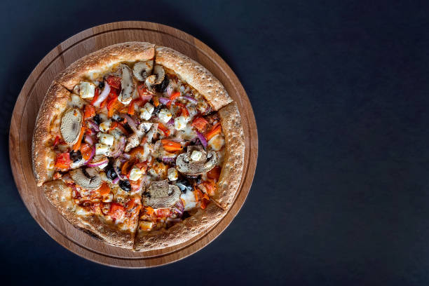 istock Pizza with vegetables on a dark background 1257822996