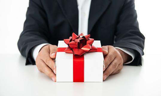 Business man giving gift box.
