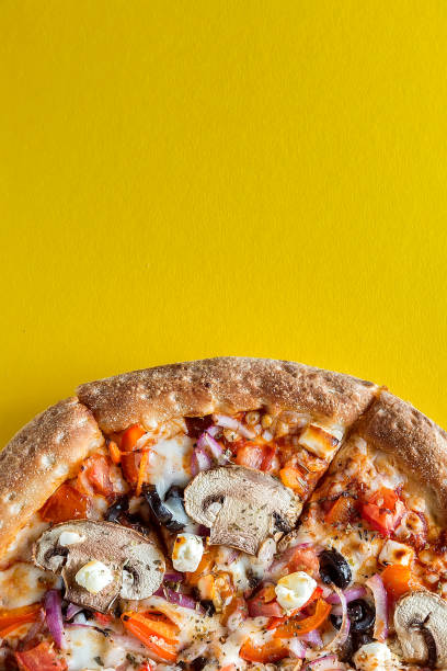 istock Pizza with vegetables on a bright yellow background. 1257823116