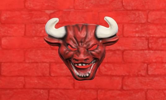 red devil mask on red brick wall