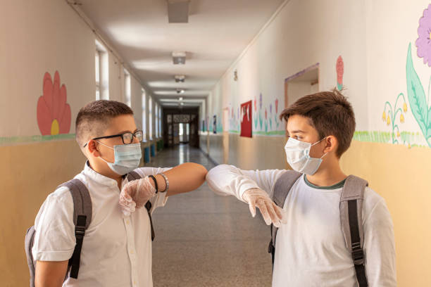 istock Two boys respecting social distance in school 1257826230