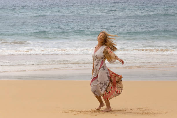 istock Woman dancing in the beach 1257827839