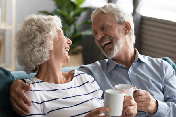 istock Happy mature couple having fun, drinking tea at home together 1257831205