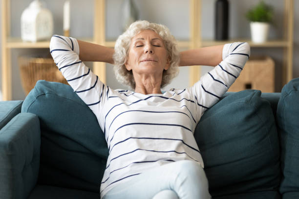 istock Peaceful calm older woman leaning back on couch 1257831232